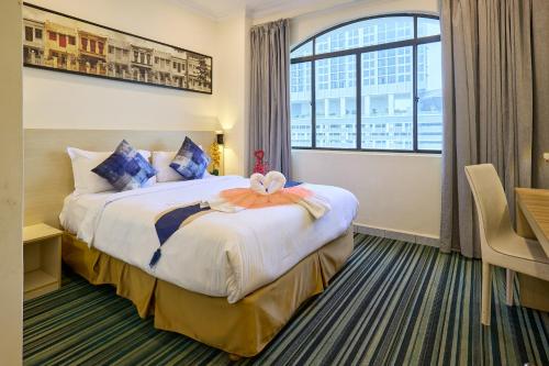 a hotel room with a large bed with a window at Hotel Bintang Kuala Lumpur in Kuala Lumpur