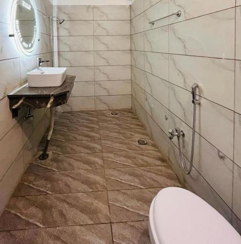 a bathroom with a sink and a toilet at Hotel Exclusive in Dargai