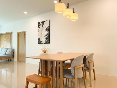 a dining room with a wooden table and chairs at Lilly Pool Villa near Krabi Airport with Free Airport Shuttle
