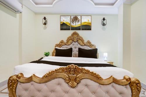 a bedroom with a large gold and white bed at Palette Heritage Varanasi Retreat in Varanasi