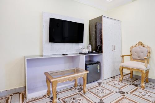 a living room with a tv and a chair at Palette Heritage Varanasi Retreat in Varanasi