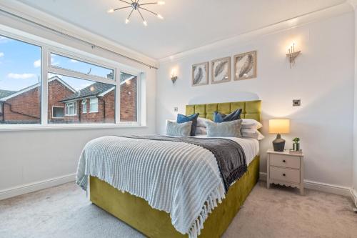 a bedroom with a bed and a window at Luxury Escape Sleeps 7 in Albrighton- 4 Beds 3 Double beds 1 single 2 Mins to M54 RAF Cosford Shifnal Telford Oxley Staffordshire -JLR Wolves Stafford I54 Business Park- 10 Mins to M6- 40 Mins to NEC Regular & Long Work Stays available - Samina- ARZ Stays in Albrighton