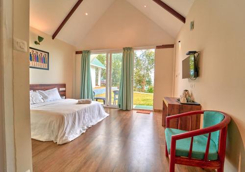 a bedroom with a bed and a large window at Gardenia Kanthalloor in Kanthalloor
