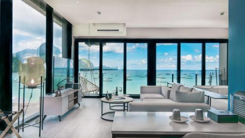 a living room with a view of the ocean at H Hotel El Nido - Vegan Friendly Hotel Managed by H Hospitality Group in El Nido