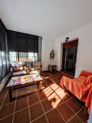 a living room with a couch and a table at Casona El Chaparral in Fondón