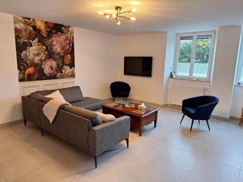 ベルジェール・レ・ヴェルテュにあるGite en Champagneのソファとテーブルのあるリビングルーム