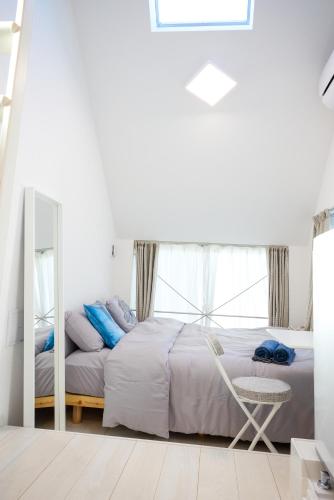 a bedroom with a bed and a mirror and a chair at 宿栖渋谷 in Tokyo