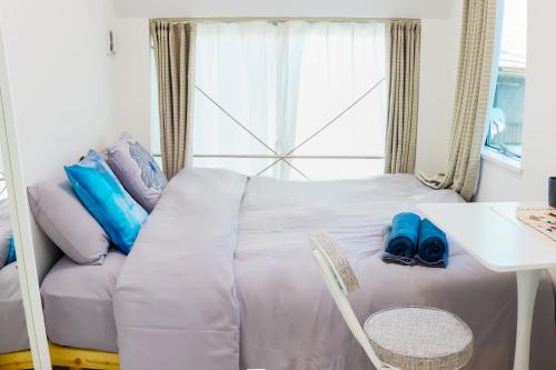 Postel nebo postele na pokoji v ubytování 宿栖渋谷