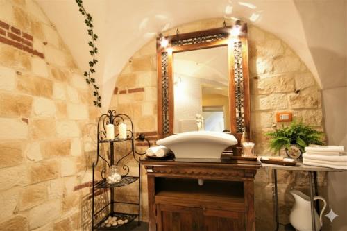 a bathroom with a sink and a mirror at da Patrick in Costarainera