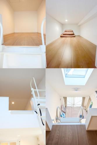 a room with white furniture and a room with wood floors at 宿栖渋谷 in Tokyo