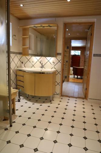 a bathroom with a sink and a mirror at Log Chalet Tallero in Luosto