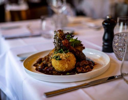 a white plate of food on a table at Veermaster in Breege