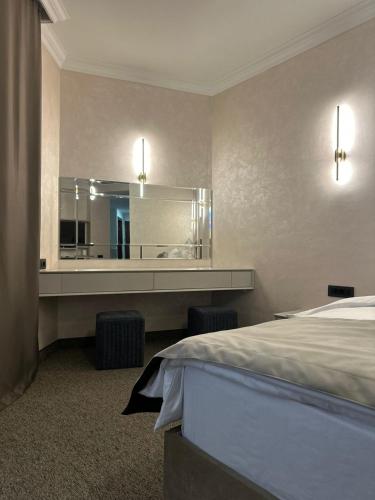 a hotel room with a bed and a large mirror at Nord Gate Avenue Hotel in Aghk'ilisa