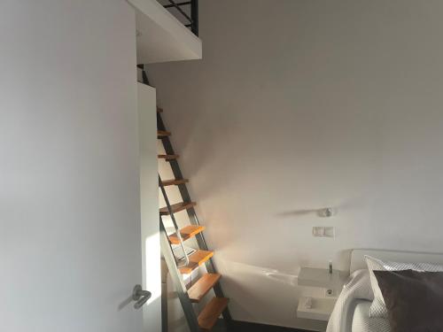 a bathroom with a ladder in a white room at Bungalow Maspalomas, Jacuzzi in Maspalomas