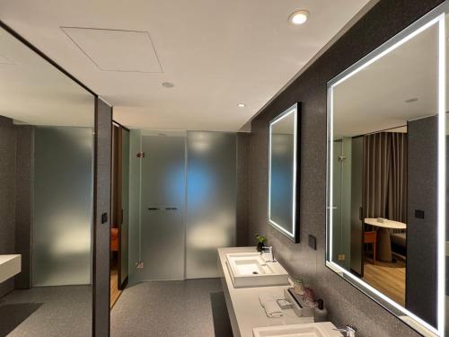 a bathroom with two sinks and a mirror at W9-Hotel ShangHai PuDong Ariport in Shanghai