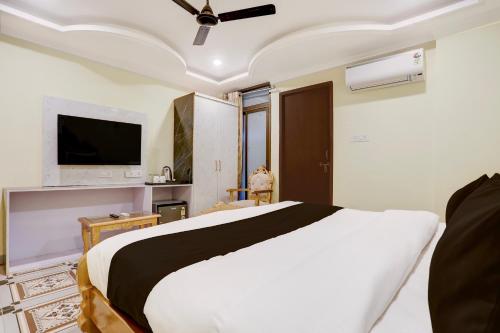 a bedroom with a bed and a flat screen tv at Palette Heritage Varanasi Retreat in Varanasi