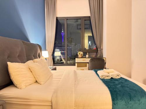 a bedroom with a bed with two towels on it at Lucentia Residence by Infinity swimming pool,lalaport KL in Kuala Lumpur