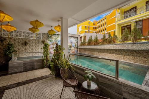 a balcony with a swimming pool in a building at Eco Hotel Hoi An in Hoi An