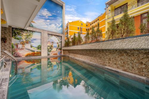 a swimming pool in a building with buildings at Eco Hotel Hoi An in Hoi An
