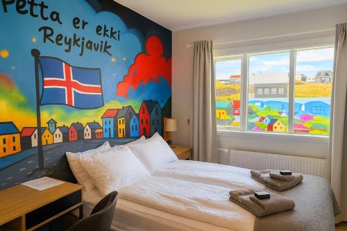 a bedroom with a bed with towels on it at The Stykkishólmur Inn by Ourhotels in Stykkishólmur
