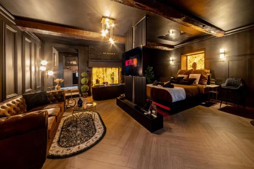 a bedroom with a bed and a living room with a couch at Le Havre de Pierres, Puy du Foù in Mauléon