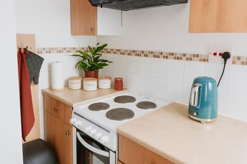 a kitchen with a stove and a counter top at The Little Nest in Colchester in Colchester