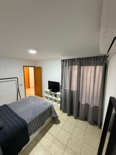 Ένα ή περισσότερα κρεβάτια σε δωμάτιο στο Casa Tamarán