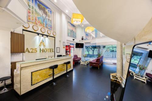 hotel lobby with a reception desk and chairs at A25 Hotel - 251 Hai Bà Trưng HCM in Ho Chi Minh City