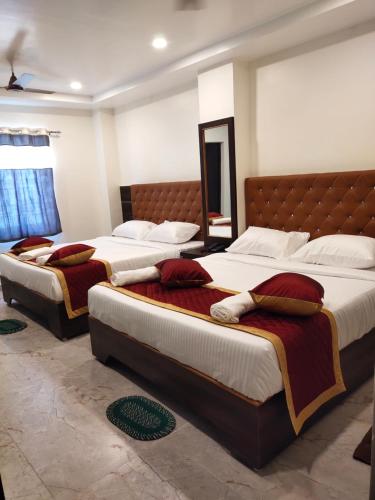 Ένα ή περισσότερα κρεβάτια σε δωμάτιο στο Santhi residency