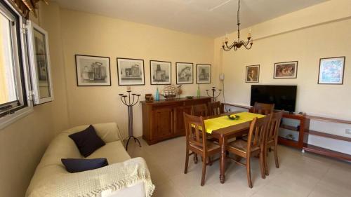 a living room with a table and a couch and a television at Suli Residences in Pesádha