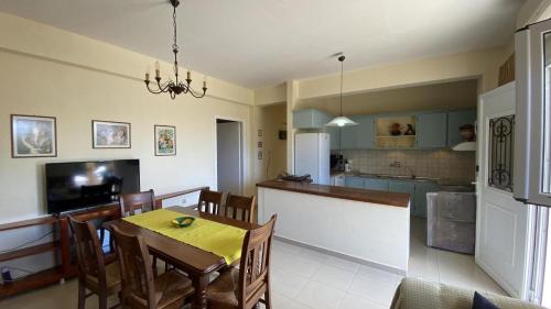 a kitchen and dining room with a table and chairs at Suli Residences in Pesádha