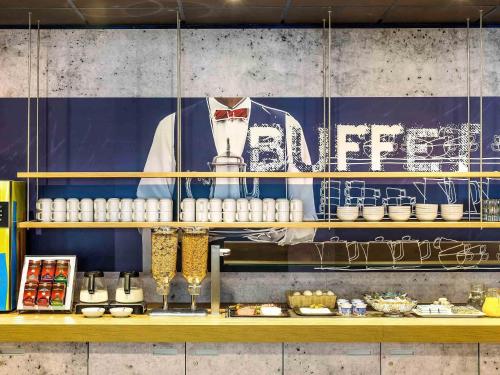 a kitchen with a counter with food on it at Ibis budget Dunkerque Grande Synthe in Grande-Synthe