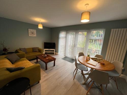 a living room with a couch and a table at Anita Croft in Birmingham