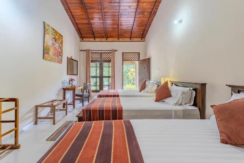 Ένα ή περισσότερα κρεβάτια σε δωμάτιο στο Blue Magpie Lodge Sinharaja