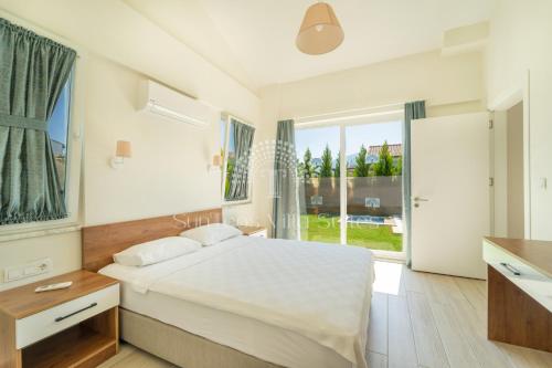 Ένα ή περισσότερα κρεβάτια σε δωμάτιο στο SunTeos Villa Suites