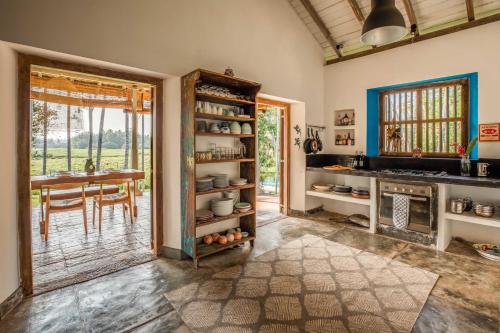 a kitchen with a table and a dining room at Rice House in Habaraduwa