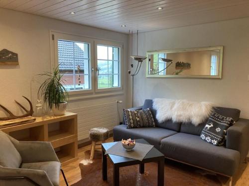a living room with a couch and a table at Im Toggi in Wattwil