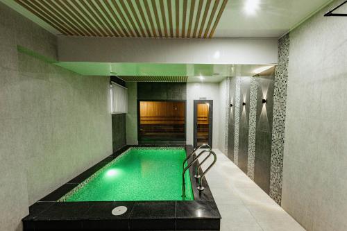 a swimming pool in the middle of a room at Residence Hotel Spa in Taraz