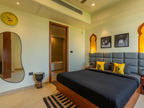 a bedroom with a large bed and a mirror at The Hosteller Agra, Tajganj in Agra