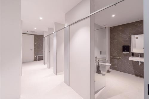 a bathroom with white walls and a toilet at Apartamentos - Delfin Natura in L'Alfas del Pi
