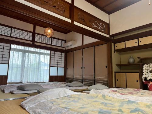 Ένα ή περισσότερα κρεβάτια σε δωμάτιο στο 旅籠屋cafeKATARI