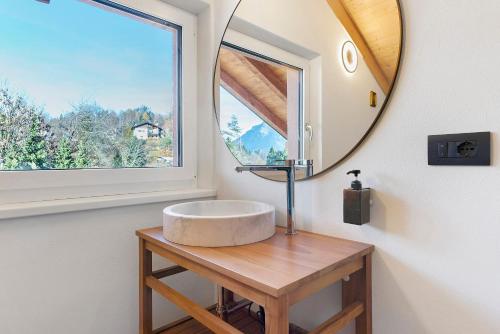 a bathroom with a round sink and a mirror at Appartamento La Téza in Lavarone