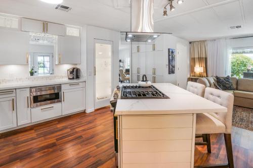 eine offene Küche und ein Wohnzimmer mit weißen Schränken in der Unterkunft Madrigal in Cathedral City