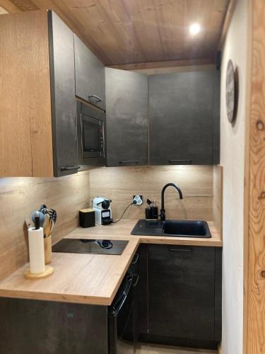 a kitchen with a sink and a counter top at Risoul 1850 studio Résidence LesFlorins2 pour 4 pers avec accès direct sur les pistes in Risoul
