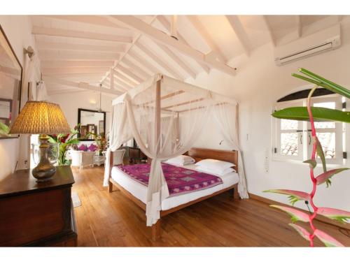 a bedroom with a white bed with a canopy at Pool, Roof Terrace, 3 Bedroom Villa, Galle Fort in Galle
