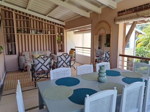 a dining room with a table and chairs at CosyNest Apartment in Cap Malheureux