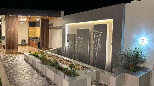 a lobby with plants on the wall of a building at شاليه هوانا in Sohar