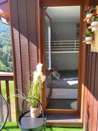 a tiny house with a bunk bed inside of it at Le Portail 76 in Valmorel