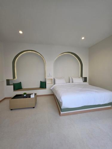 a bedroom with a large white bed and two mirrors at Villa38 