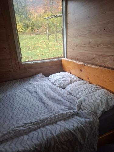 a bed in a room with a window at CASA Petra in Bituše